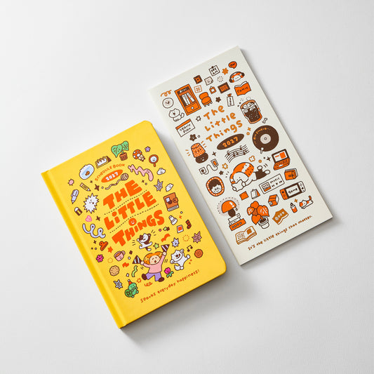 A yellow hardcover notebook and a white sheet of matching stickers, both decorated with cute cartoon illustrations and the text 'The Little Things,' photographed on a light gray background.